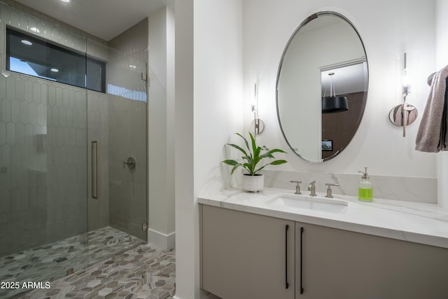 bathroom featuring walk in shower and vanity