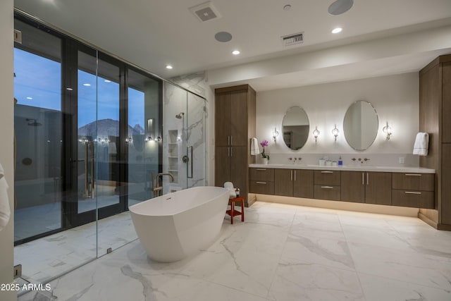 bathroom with vanity, shower with separate bathtub, and a mountain view