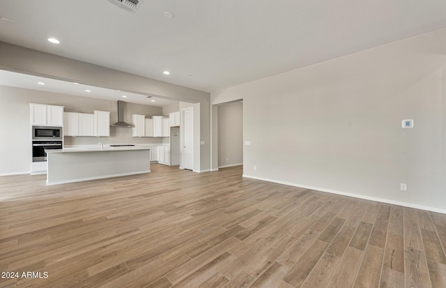 unfurnished living room with light hardwood / wood-style floors