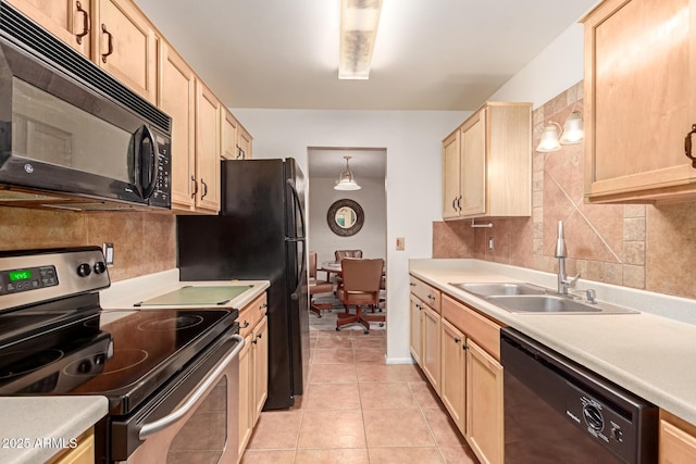 kitchen featuring pendant lighting, light brown cabinetry, sink, backsplash, and black appliances