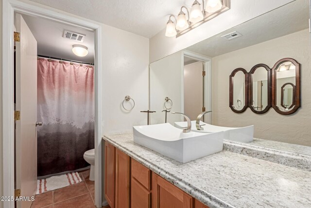 bathroom with tile patterned floors, toilet, and vanity