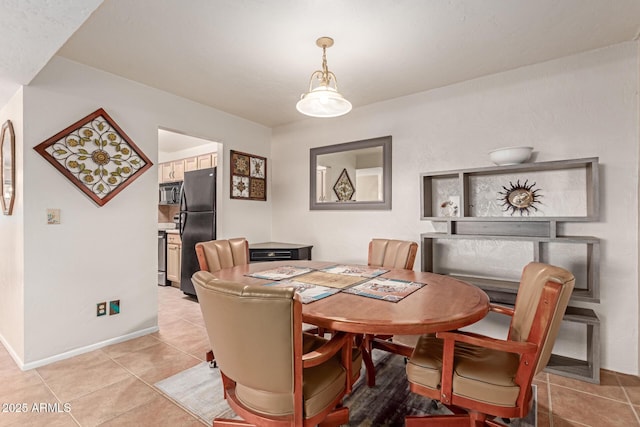 dining space featuring light tile patterned floors