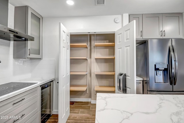 35005 N Central Ave, Phoenix, AZ 85086 - kitchen with stainless steel fridge with ice dispenser, wall chimney exhaust hood, beverage cooler, gray cabinetry, and recessed lighting