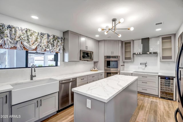 35005 N Central Ave, Phoenix, AZ 85086 - kitchen with wine cooler, gray cabinetry, wall chimney range hood, appliances with stainless steel finishes, and recessed lighting
