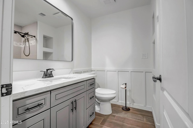35005 N Central Ave, Phoenix, AZ 85086 - bathroom with toilet, a decorative wall, a wainscoted wall, vanity, and wood finished floors
