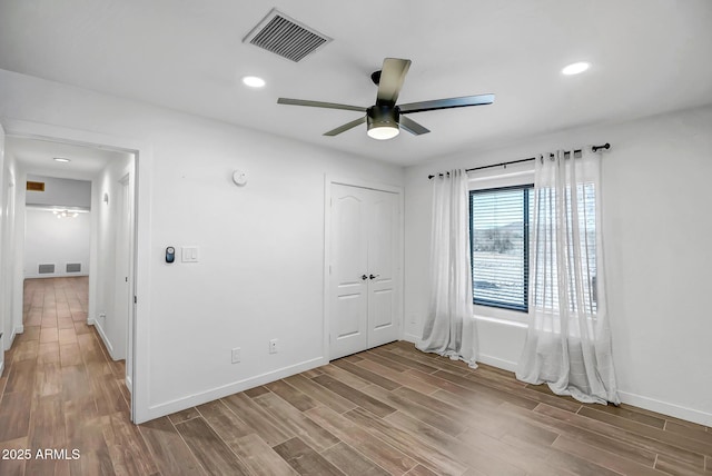 35005 N Central Ave, Phoenix, AZ 85086 - unfurnished bedroom with baseboards, wood finished floors, recessed lighting, a closet, and ceiling fan