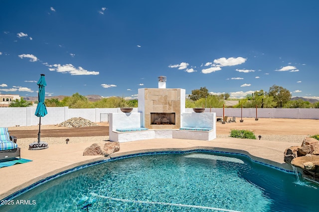 35005 N Central Ave, Phoenix, AZ 85086 - view of swimming pool featuring a fireplace, a patio area, and fence