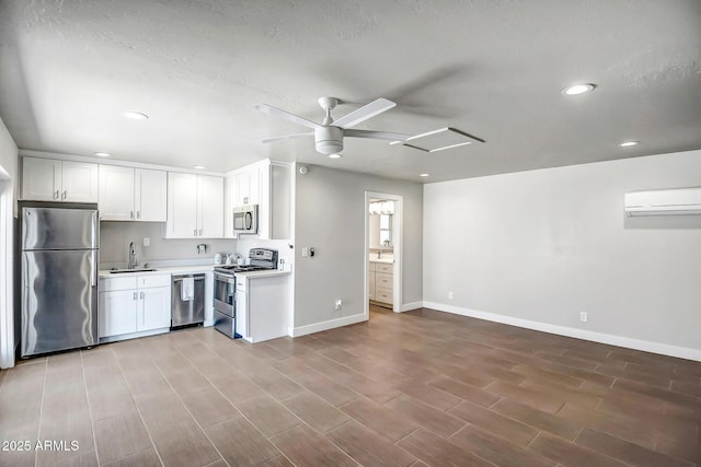 35005 N Central Ave, Phoenix, AZ 85086 - kitchen with stainless steel appliances, an AC wall unit, a sink, baseboards, and recessed lighting