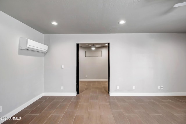 35005 N Central Ave, Phoenix, AZ 85086 - below grade area with an AC wall unit, baseboards, recessed lighting, and dark wood-style floors