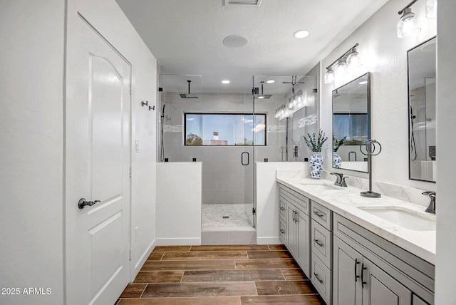 35005 N Central Ave, Phoenix, AZ 85086 - full bath featuring a stall shower, wood tiled floors, double vanity, recessed lighting, and baseboards