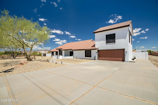 35005 N Central Ave, Phoenix, AZ 85086 - mediterranean / spanish-style home featuring a garage, stucco siding, a tile roof, concrete driveway, and fence