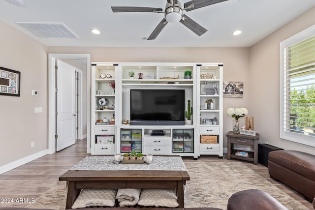 living room with ceiling fan and light hardwood / wood-style floors