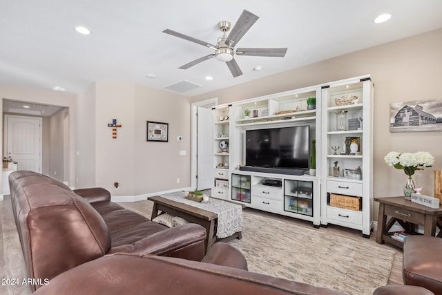 living room featuring ceiling fan and light hardwood / wood-style flooring