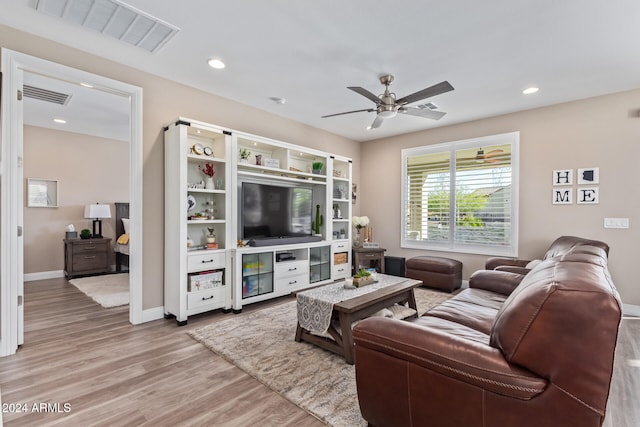 living room featuring ceiling fan and hardwood / wood-style flooring