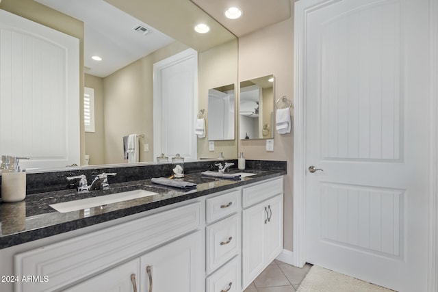 bathroom with tile patterned flooring, vanity, and toilet