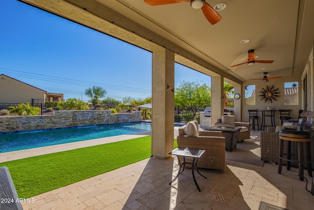 view of patio / terrace featuring pool water feature and a bar