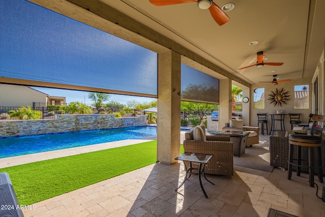 view of patio / terrace with pool water feature and a bar