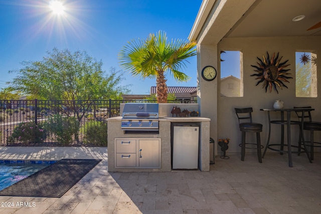 view of patio with area for grilling, grilling area, and a swimming pool