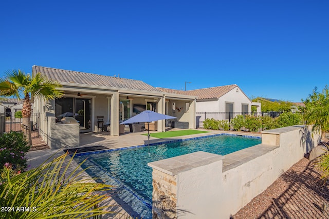 view of swimming pool featuring ceiling fan and a patio area