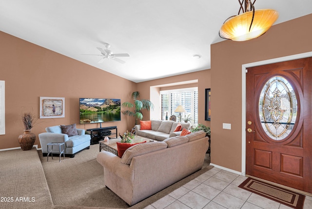 entrance foyer with light tile patterned floors, baseboards, a ceiling fan, and vaulted ceiling