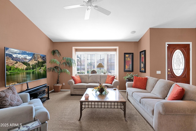 living area featuring a ceiling fan and carpet