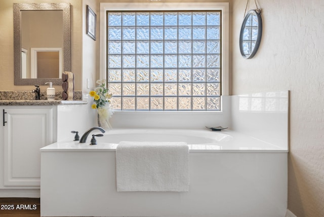 bathroom with vanity and a bathtub