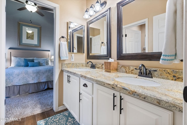 bathroom featuring hardwood / wood-style flooring, ceiling fan, and vanity