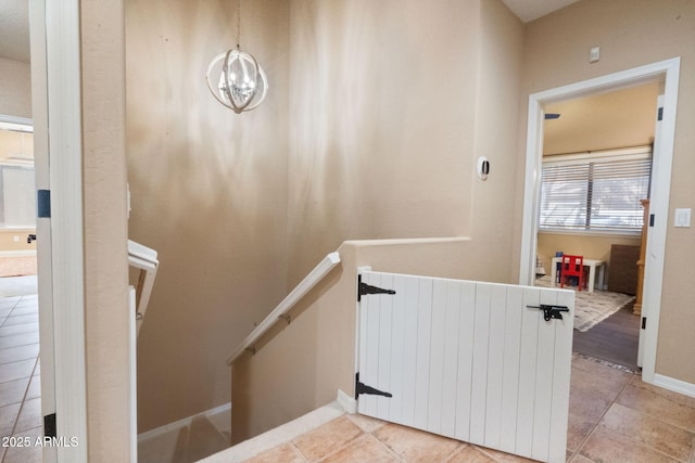 stairway featuring an inviting chandelier, radiator, and tile patterned flooring