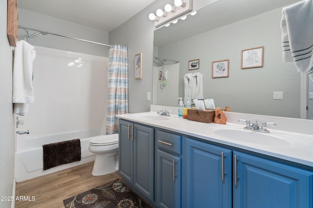 full bathroom featuring vanity, hardwood / wood-style floors, shower / bath combination with curtain, and toilet