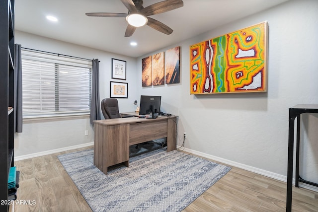 home office with ceiling fan and light hardwood / wood-style floors