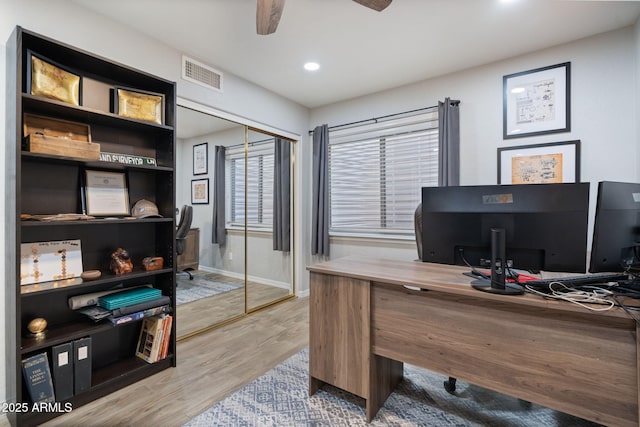 home office featuring hardwood / wood-style flooring and ceiling fan