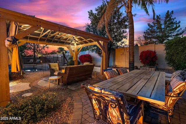 patio terrace at dusk featuring an outdoor living space