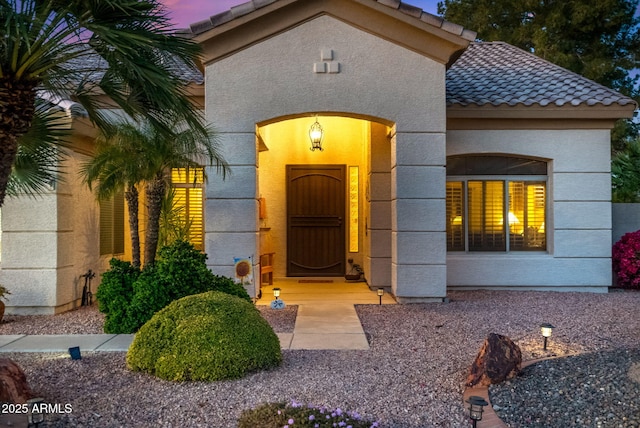 view of exterior entry at dusk