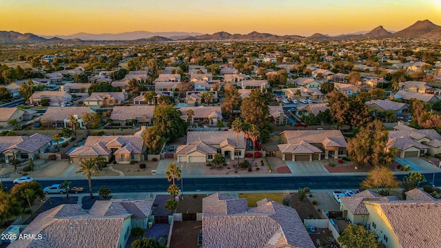 aerial view at dusk featuring a mountain view