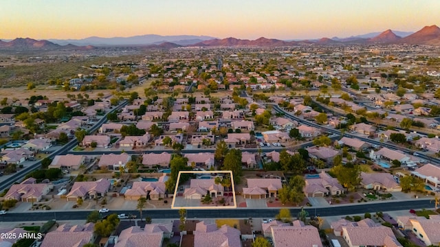 aerial view at dusk featuring a mountain view