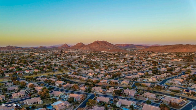 aerial view at dusk featuring a mountain view