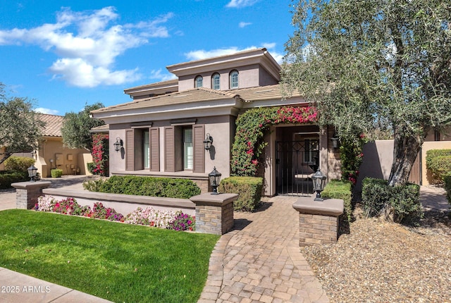 prairie-style house featuring a front lawn and stucco siding