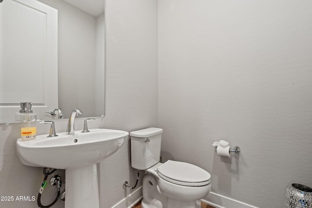 bathroom featuring toilet and sink