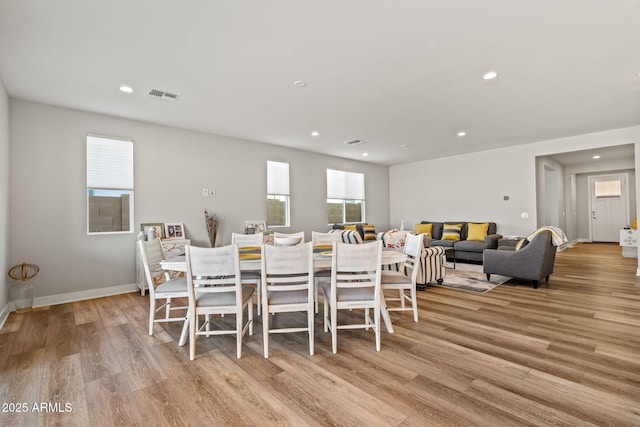 dining space with light hardwood / wood-style floors