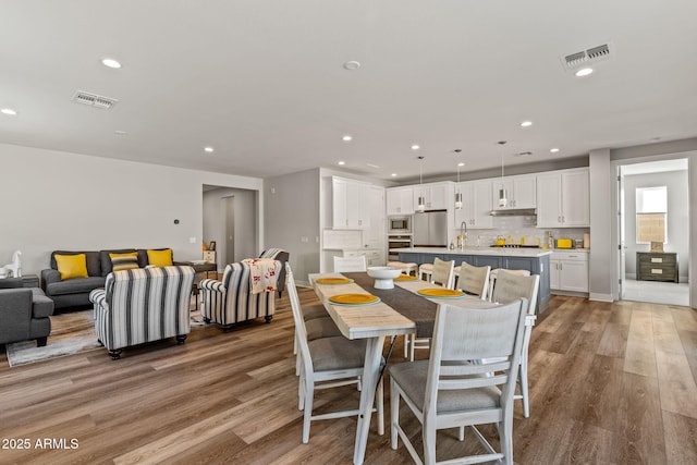 dining space with light hardwood / wood-style floors