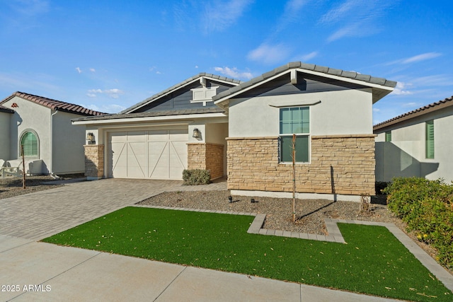 view of front of property featuring a garage and a front lawn