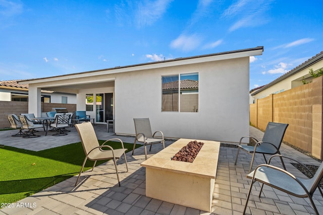 back of house featuring a patio and an outdoor fire pit