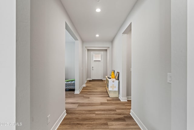 corridor with hardwood / wood-style floors