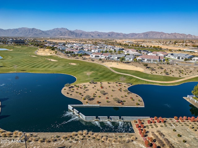 drone / aerial view with a water and mountain view