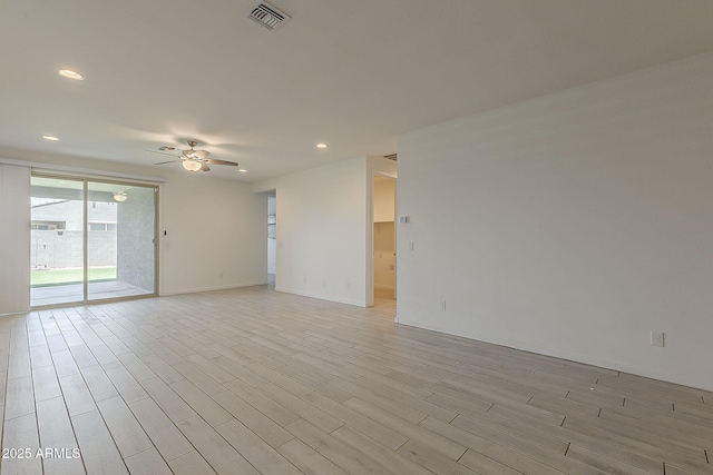 empty room with a ceiling fan, recessed lighting, light wood-style flooring, and baseboards