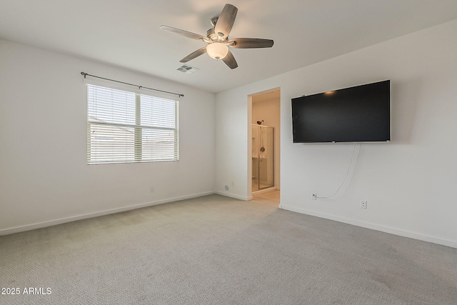 unfurnished room featuring a ceiling fan, light carpet, and baseboards
