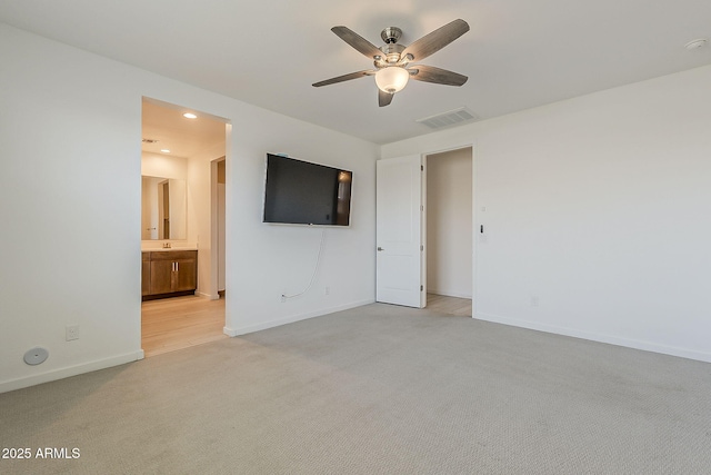 unfurnished bedroom with light carpet, baseboards, recessed lighting, connected bathroom, and a ceiling fan