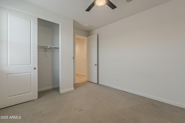 unfurnished bedroom featuring carpet floors, baseboards, a closet, and a ceiling fan