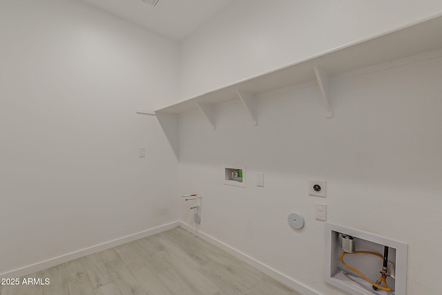 clothes washing area with gas dryer hookup, light wood-type flooring, washer hookup, electric dryer hookup, and baseboards