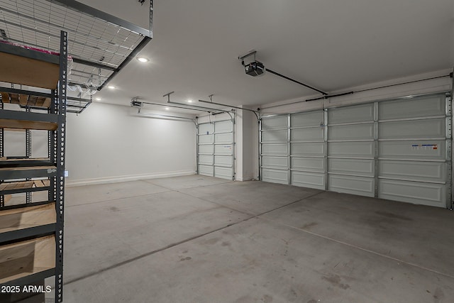 garage with a garage door opener and baseboards